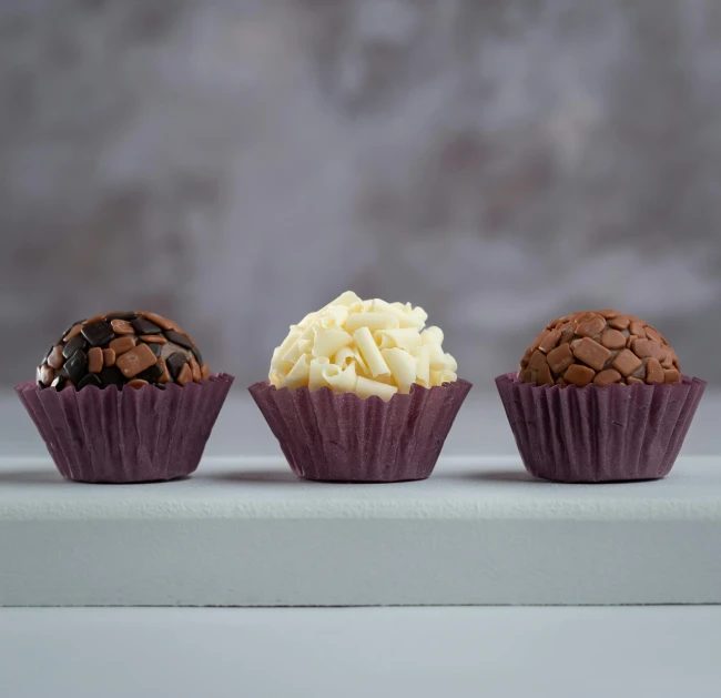 three desserts are placed on the counter next to each other