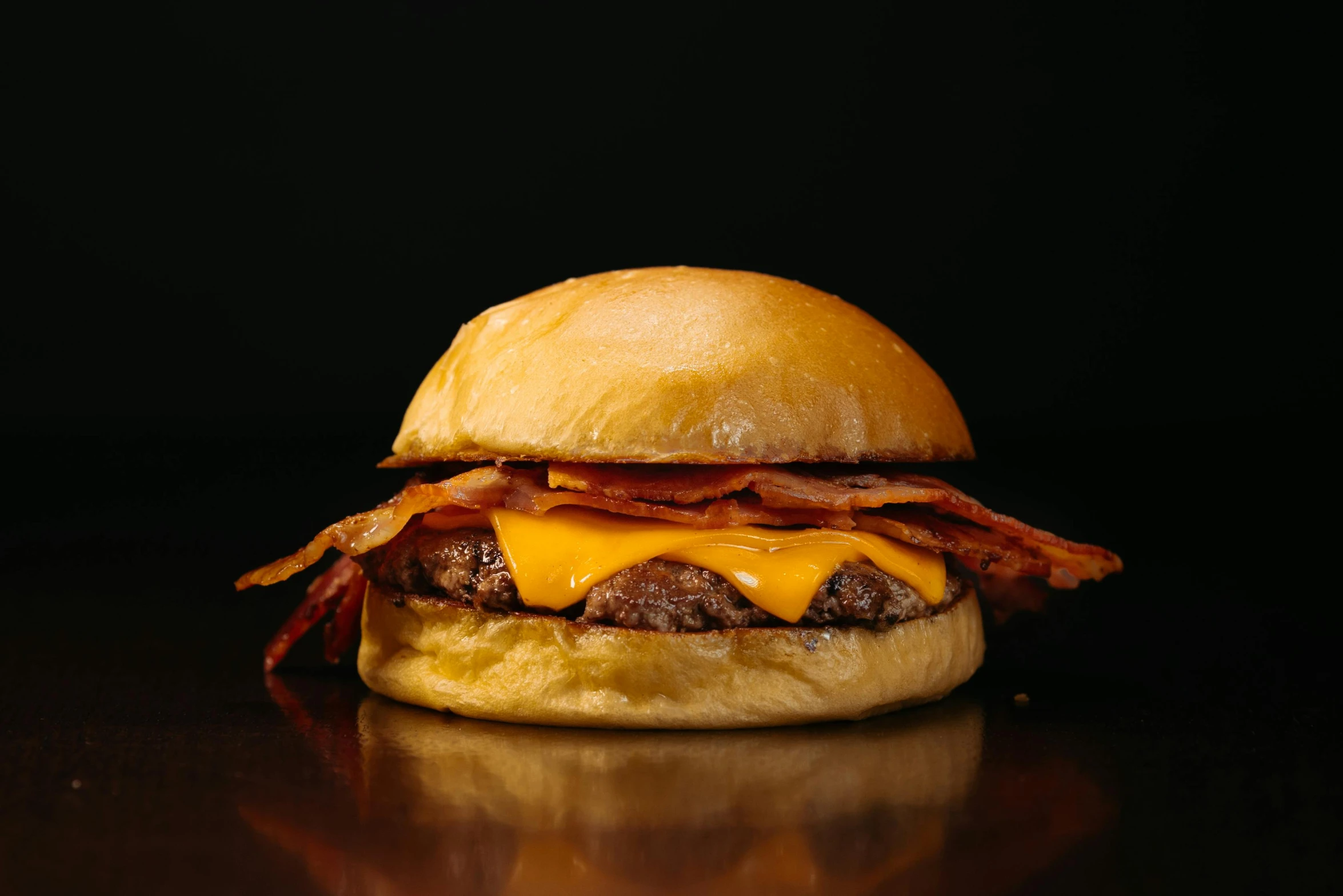 an egg bacon and cheese sandwich sits on a table