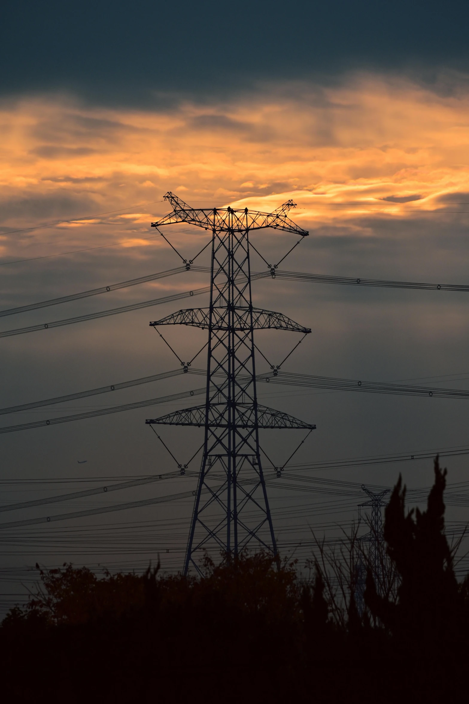 large power lines with a sunset behind them