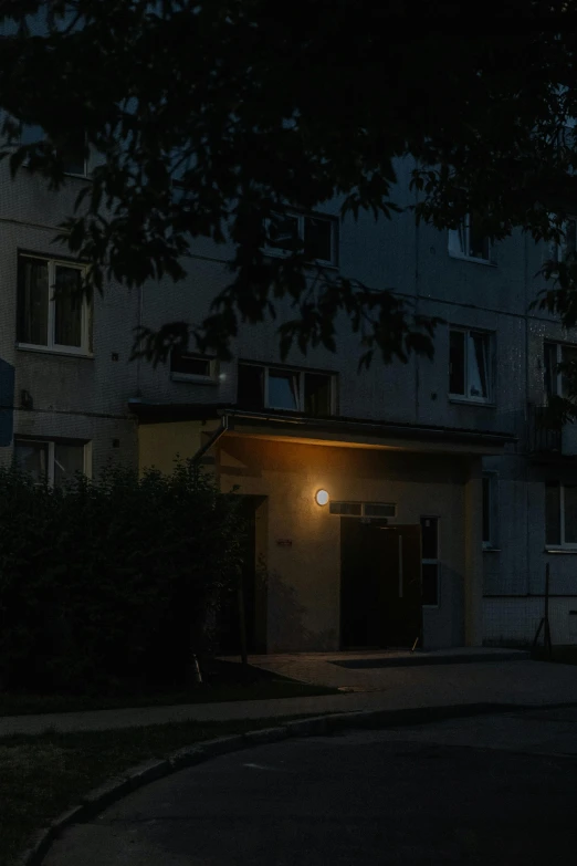 a building with a lit street light on it's side