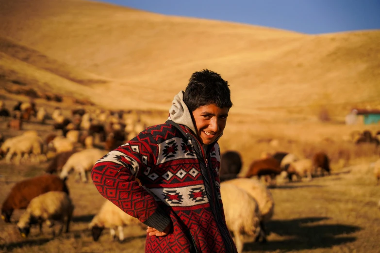 a man standing in front of a herd of sheep