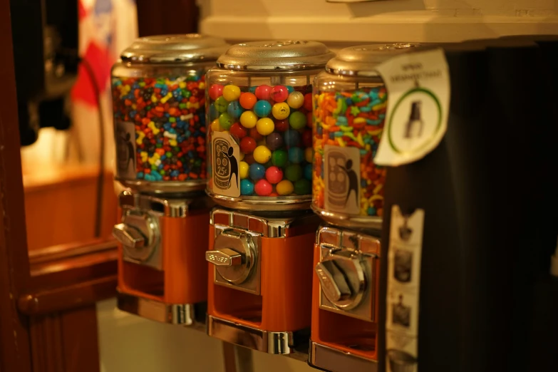 a few candy machines sit on the counter