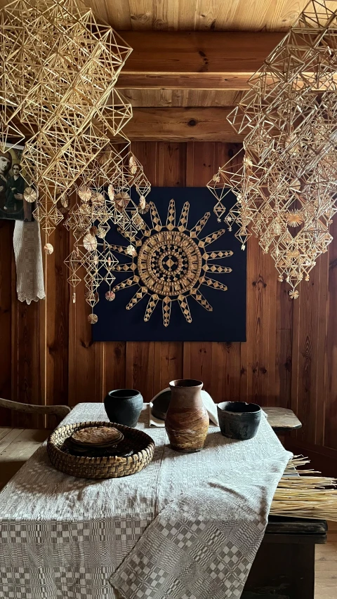 an oriental arrangement with a table and four hanging bowls