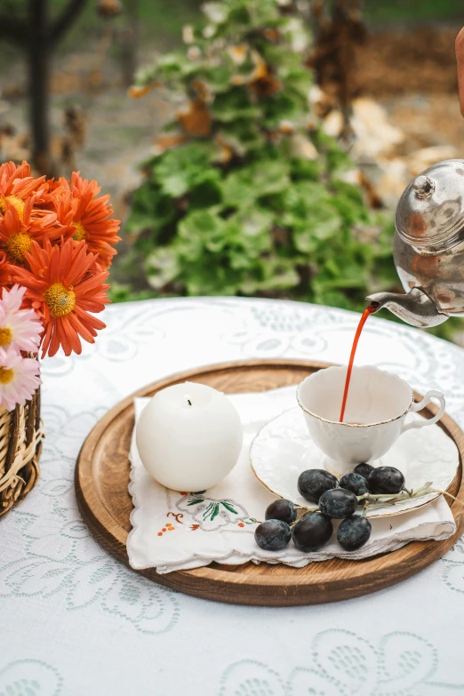 the table is set with orange and white flowers and an empty milk pitcher