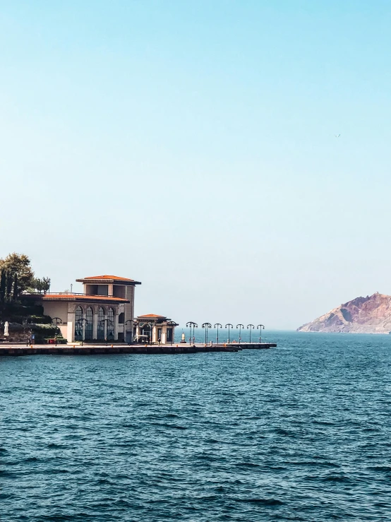 a very tall house sitting on top of a lake