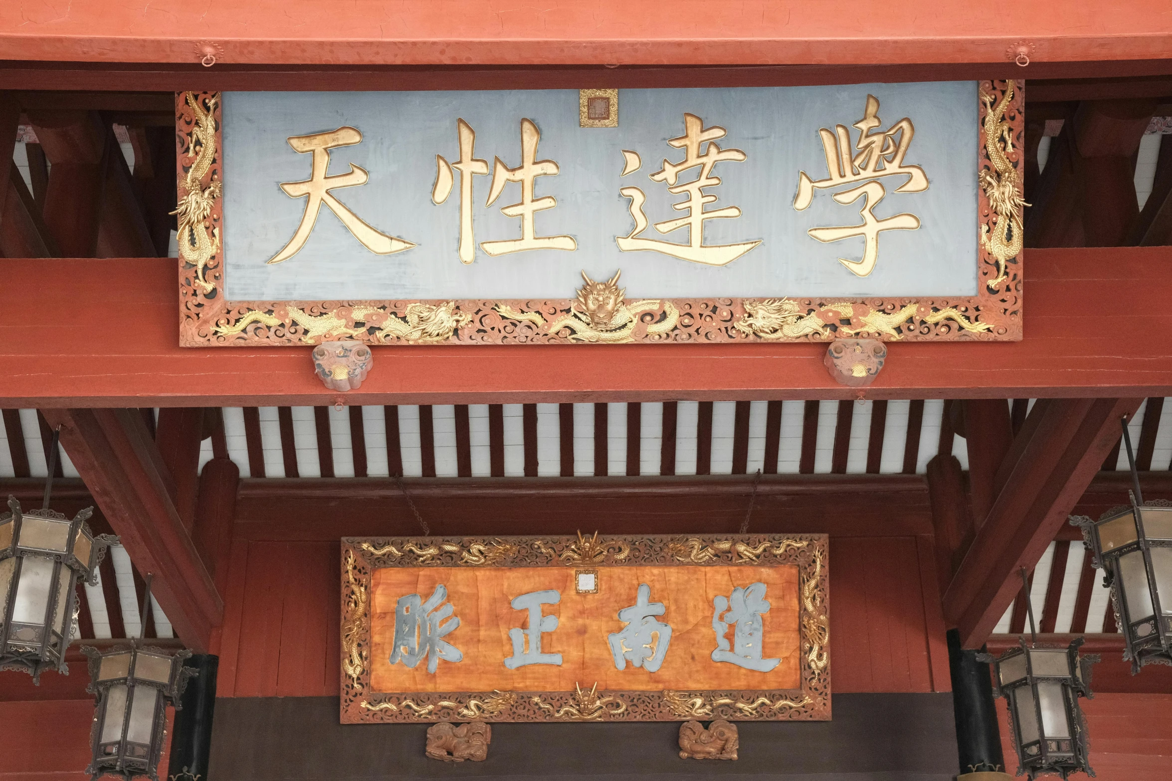 asian signs are hanging on the roof of an asian building