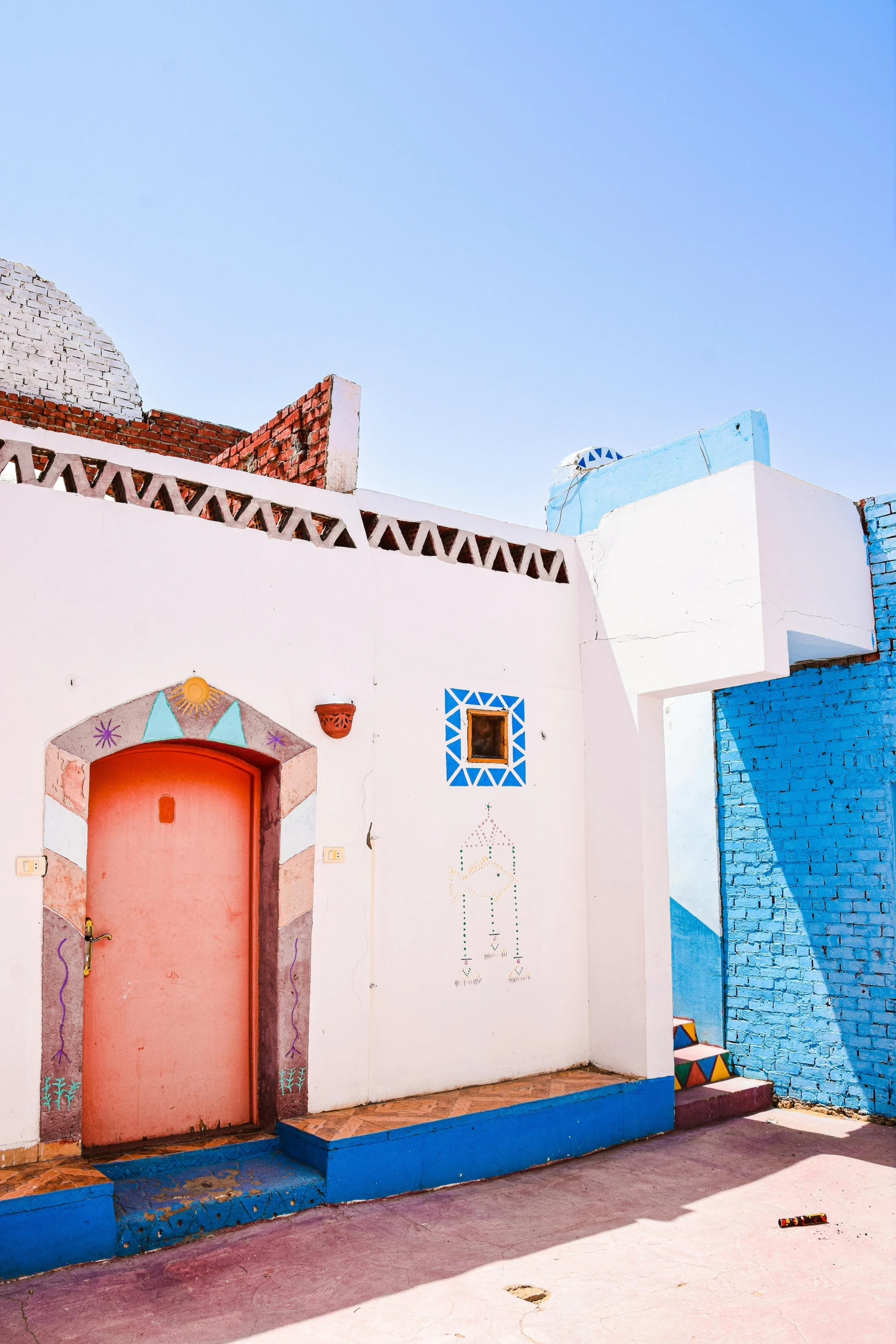 an outdoor courtyard with blue and pink accents