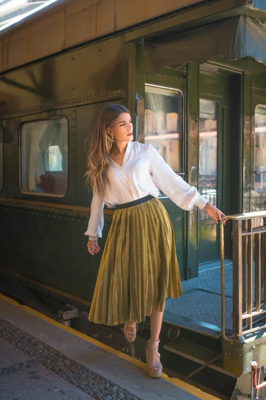 a woman poses for a picture outside a train