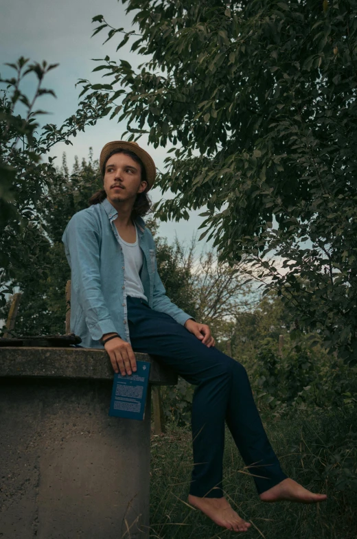 a woman sitting in the shade of a tree