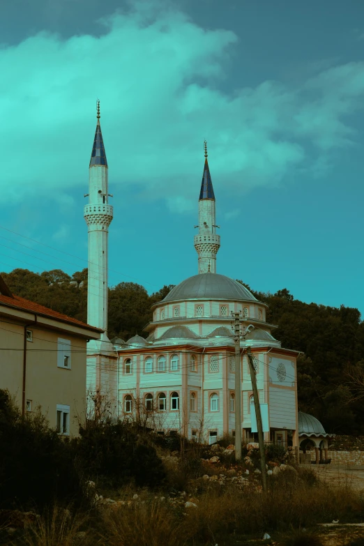 a building with three pointed towers and a roof