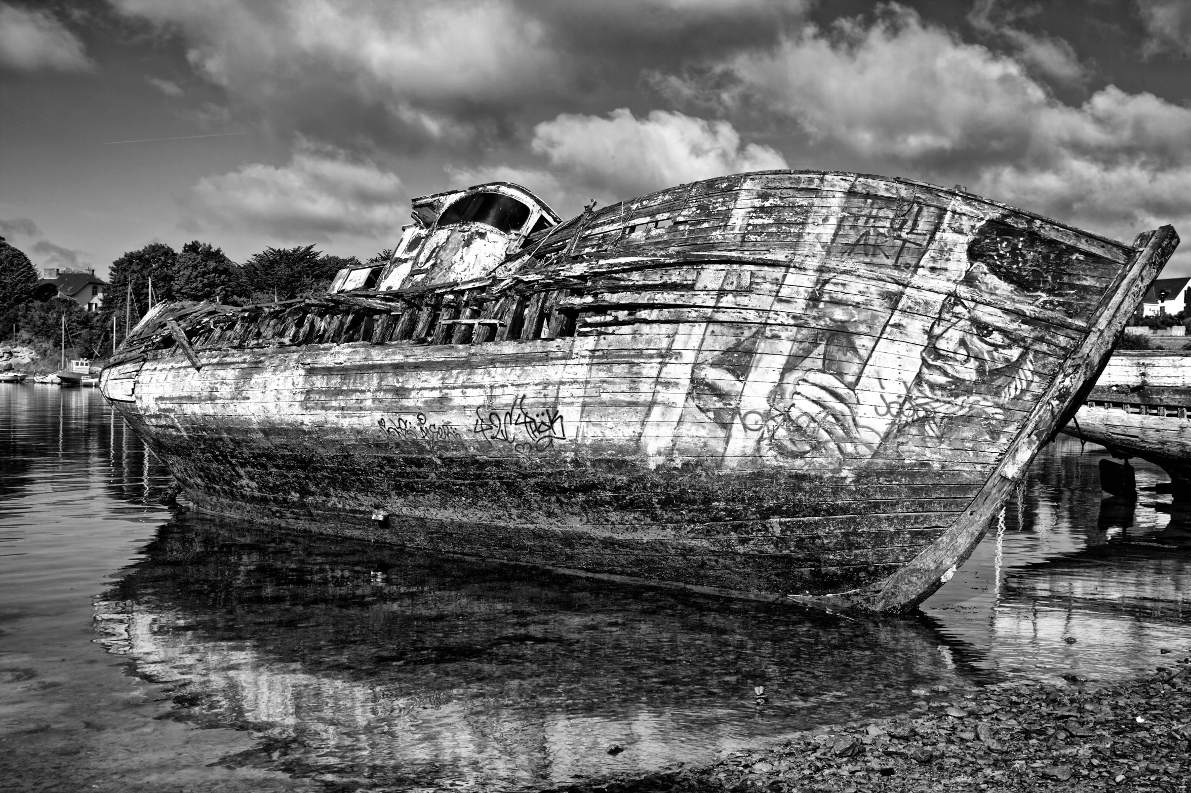 a very old wooden boat on the water