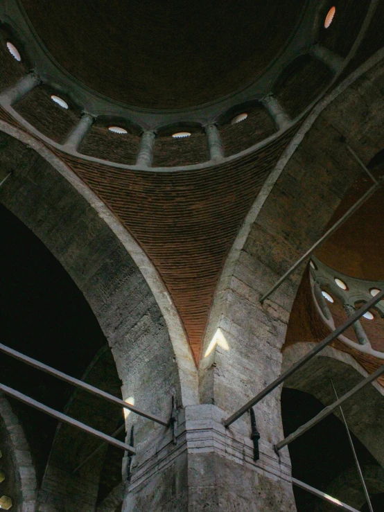 a clock tower in an abandoned building with lights on