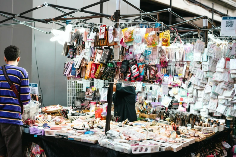 the man is looking through many items on display