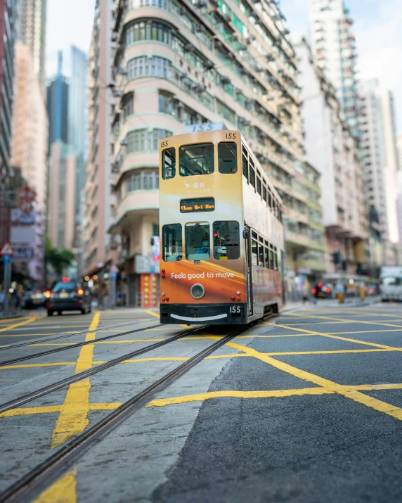 a double decked bus on the street surrounded by tall buildings