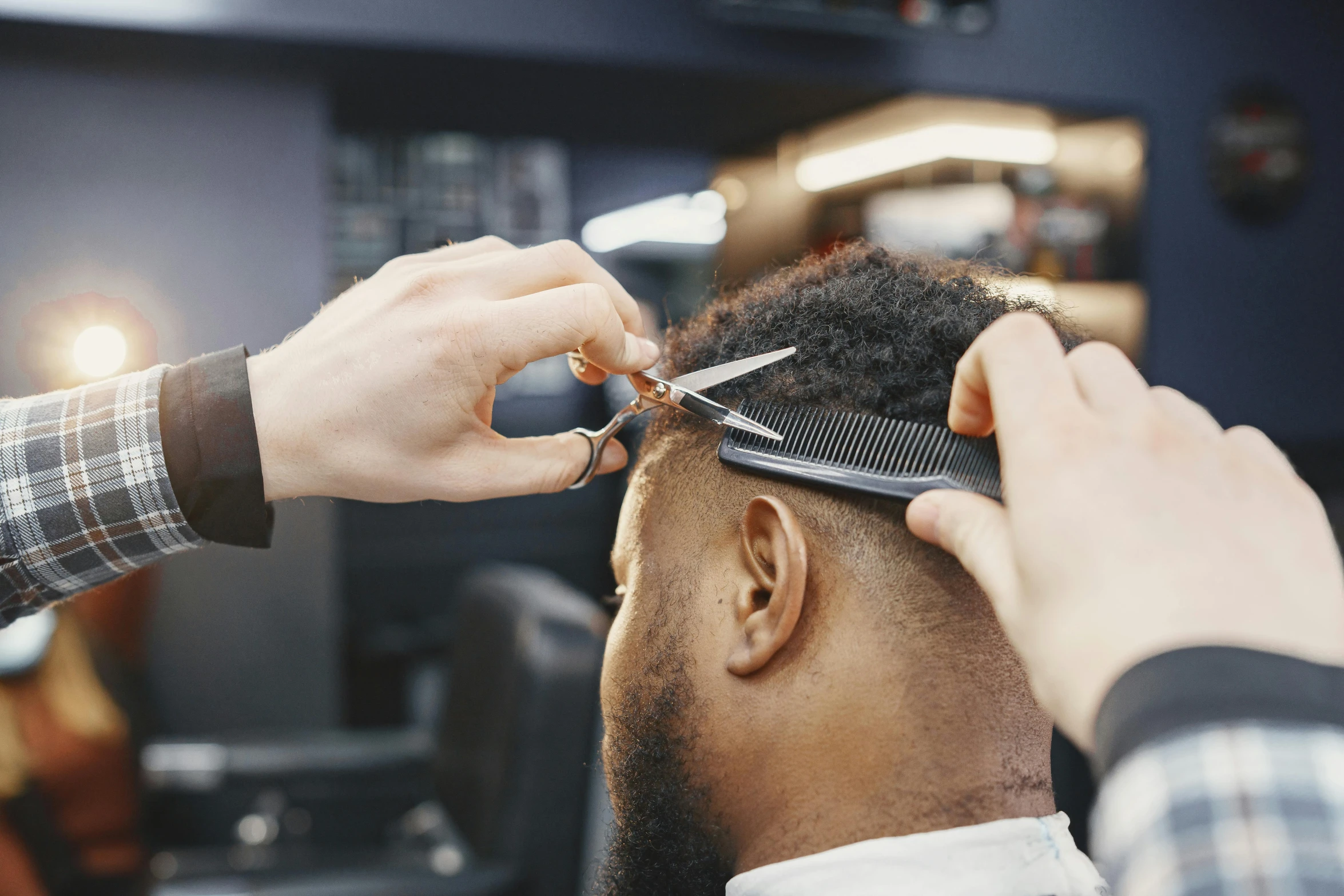 a man is  his hair in a salon