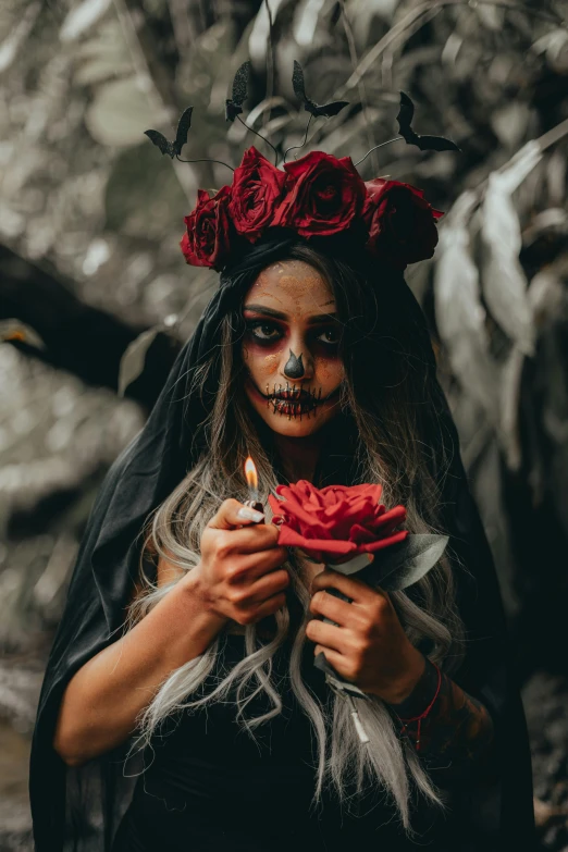 a woman with flowers on her head holding a flower