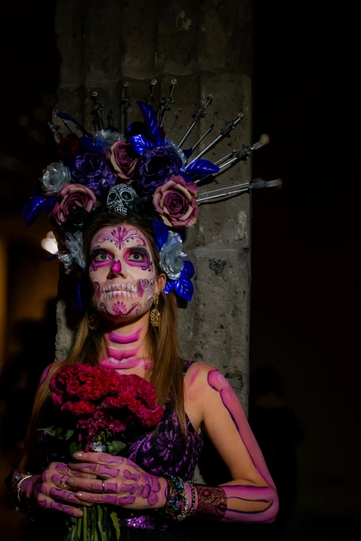 a woman wearing bright makeup and pink flowers