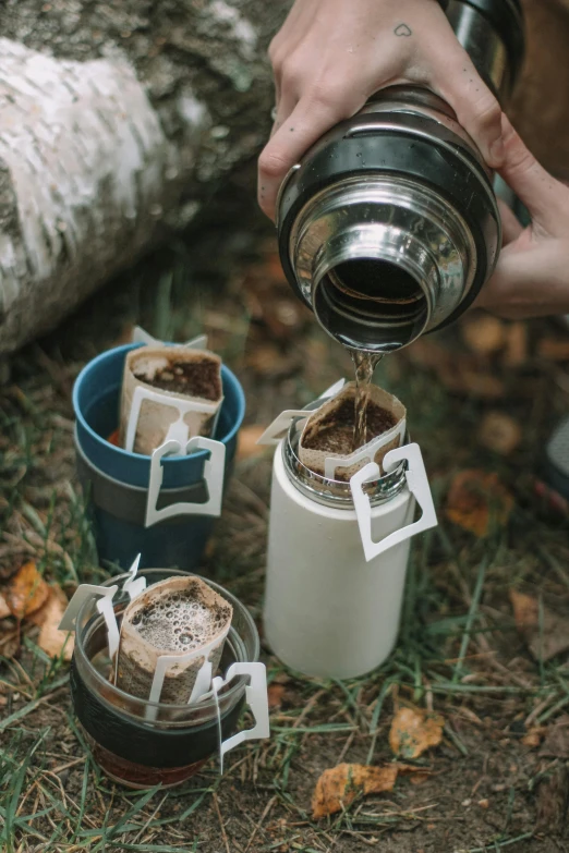 someone pours a tea into two cups