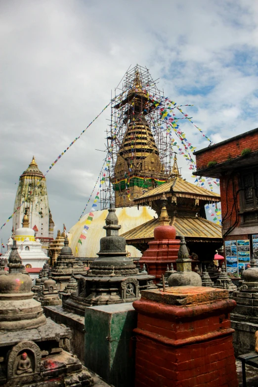 an ornate building with a large, elaborate spire next to several smaller buildings