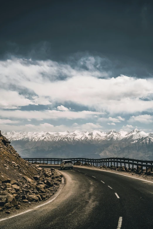 there is a very long road with a mountain in the background