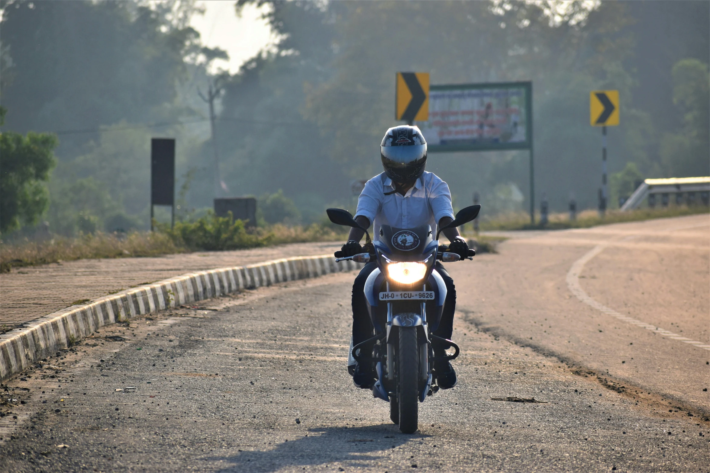 a police officer riding his motorcycle down the street