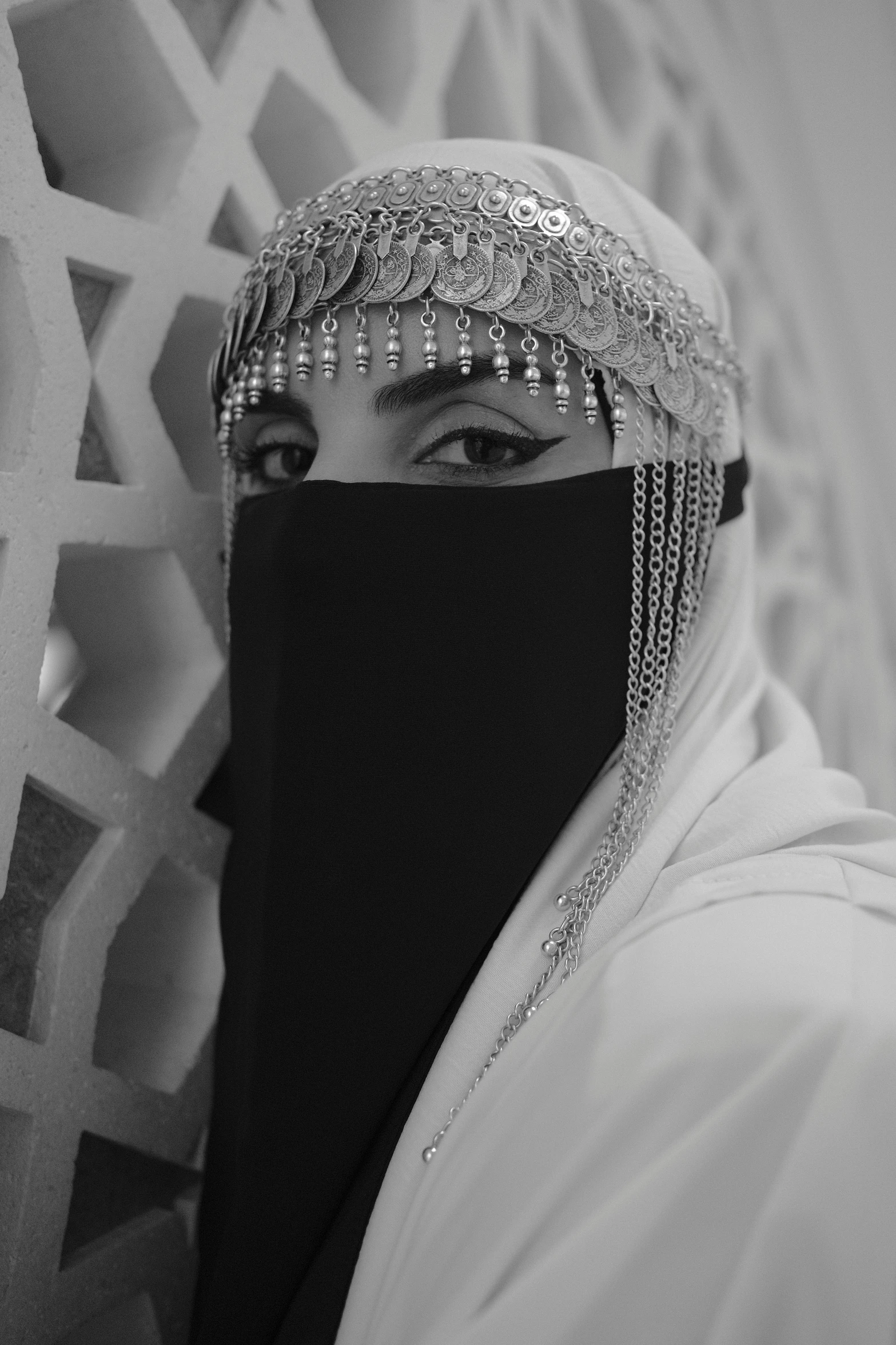 a woman in a veil poses with her head covered