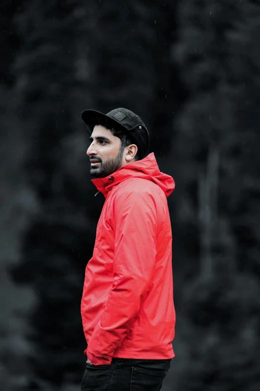 a man in a red jacket looking off to the side