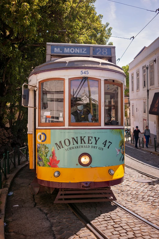 a colorful trolley is on the tracks in the city