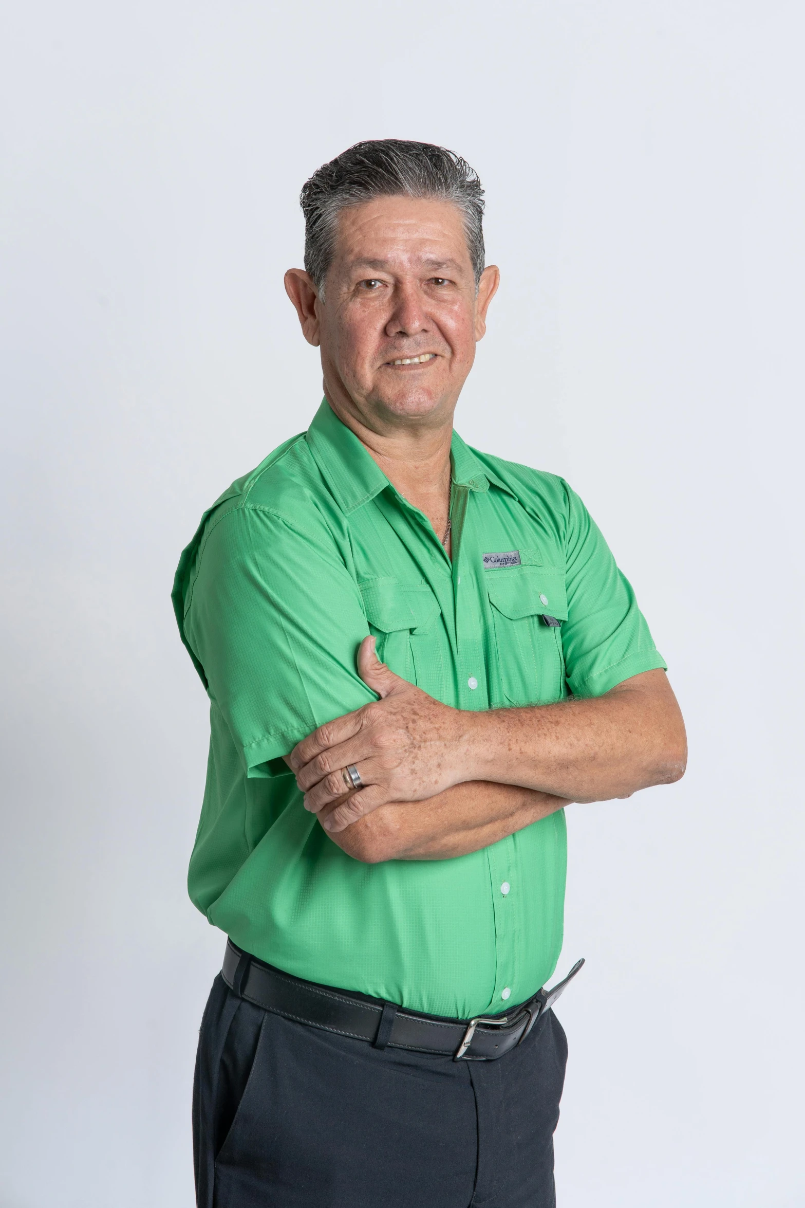 an older man in a green shirt poses for a po