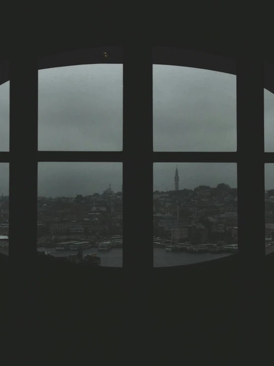 a window in an apartment looking at a city