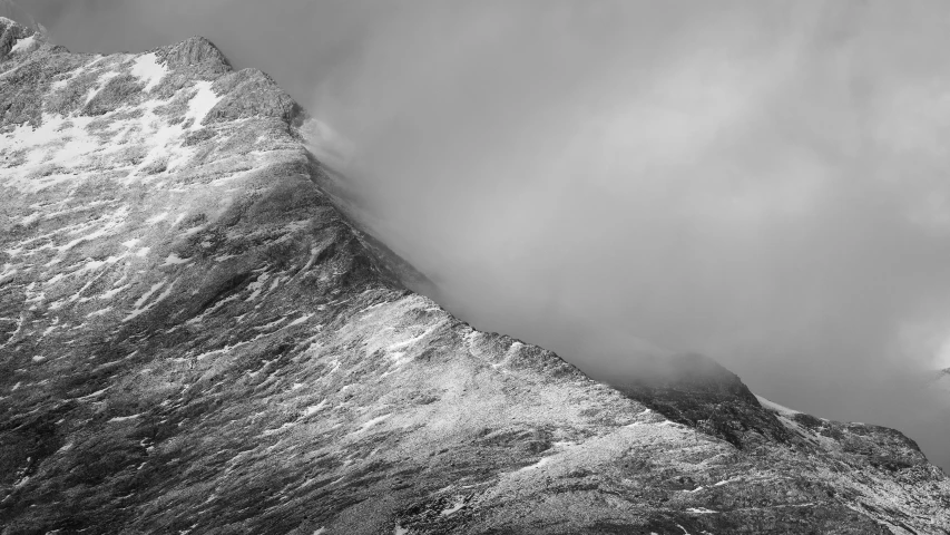 an airplane flies above snow capped mountains