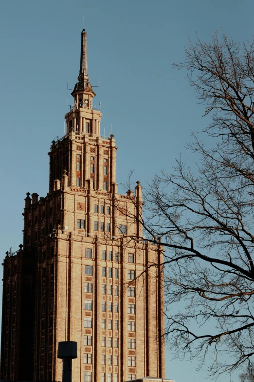 the building has a tall spire with a cross on the side of it