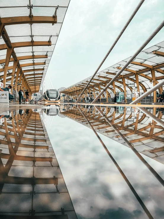 people walking in front of a building, a reflection on the water