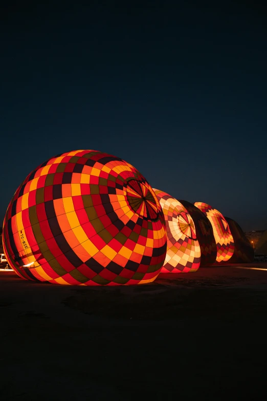 the large balloons are lit up with bright lights