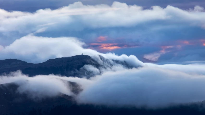 a mountain with a very pretty sky in the background