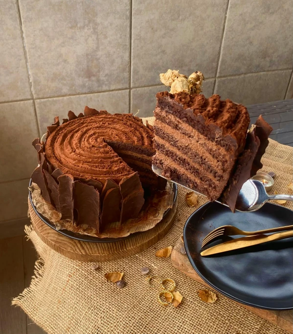 some chocolate pieces on a table next to a piece of cake