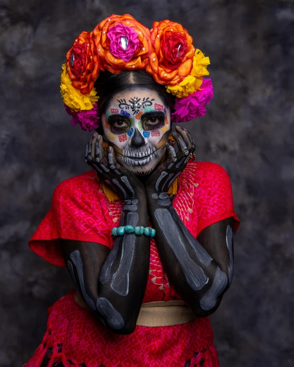 a young mexican woman wearing makeup and flower crowns