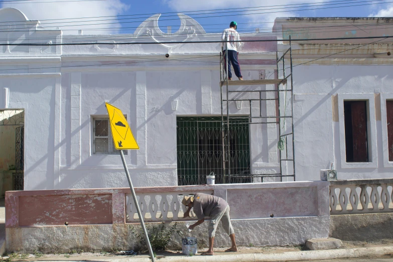 a person who is standing on a ladder with a sign