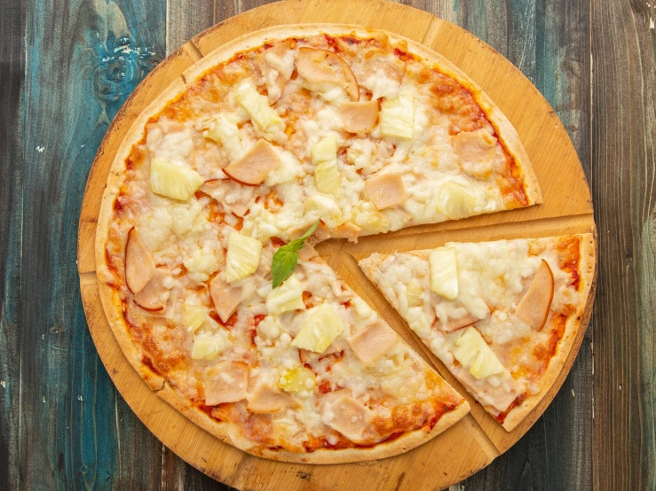 a pizza sitting on top of a wooden tray on top of a table