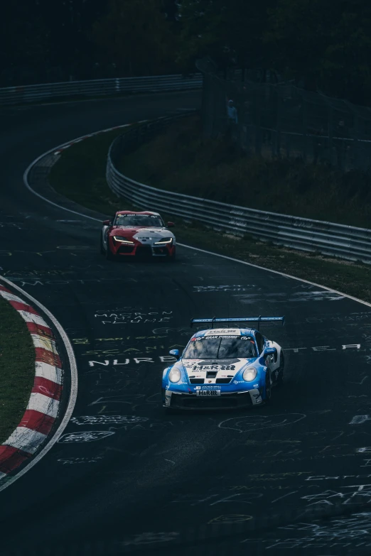 three cars racing around the track in one direction