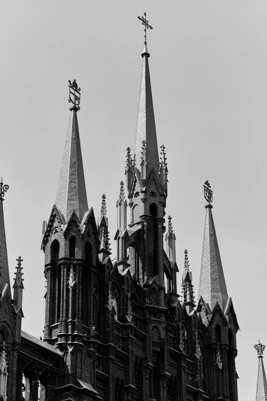 black and white pograph of a church spire with some cross in the roof