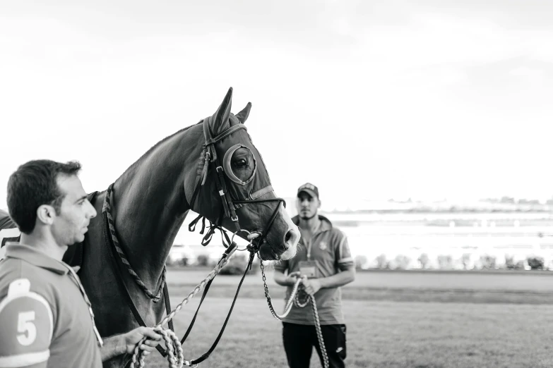 black and white pograph of people on a horse