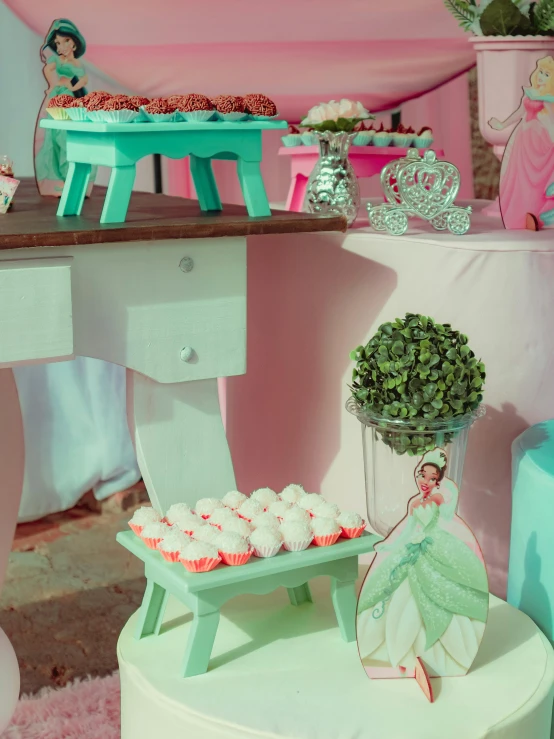 some cupcakes and a vase with flowers on a table