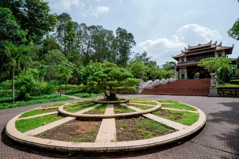 a circular stone area with an elaborate tree