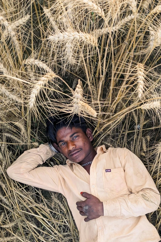 a man standing under the sun by some grass