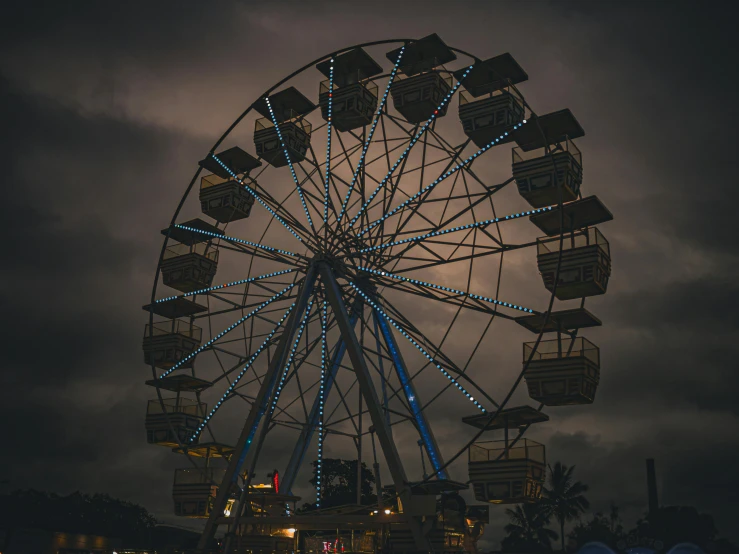 a ferris wheel lit up in blue and white