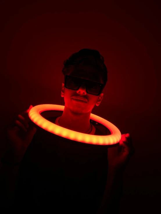 a person holding a neon tube in his hands