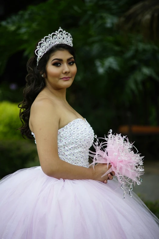 a woman poses for a picture with her dress made out of tulle