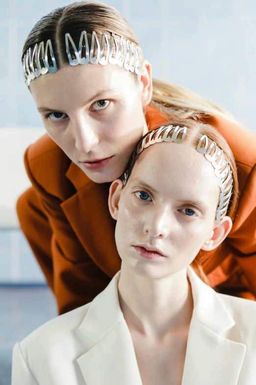 two young women with futuristic hair and head jewelry