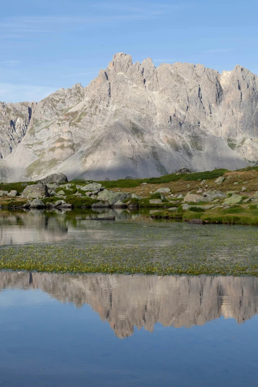 a mountain view with a body of water near a forest